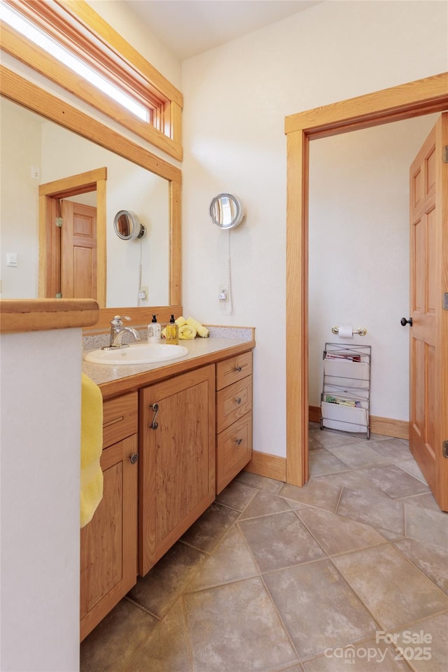 bathroom with vanity and baseboards