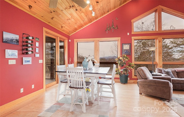 dining room with wooden ceiling, wood finished floors, baseboards, and high vaulted ceiling