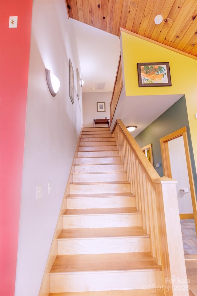 stairs featuring visible vents, lofted ceiling, and wood ceiling