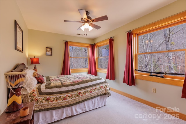 bedroom with visible vents, baseboards, and ceiling fan