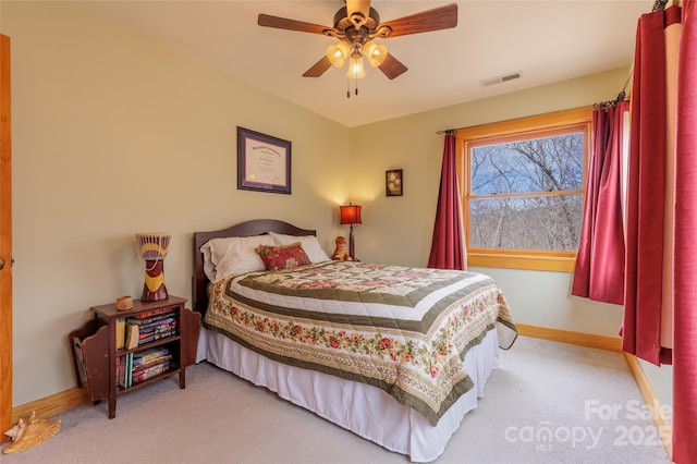 bedroom with ceiling fan, baseboards, visible vents, and light carpet