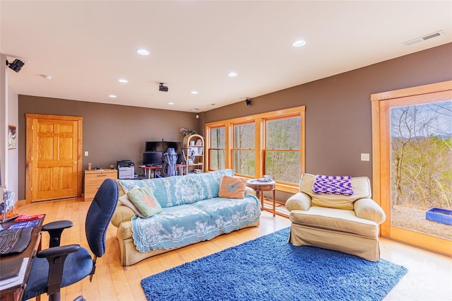 living room with light wood-style floors, recessed lighting, and visible vents