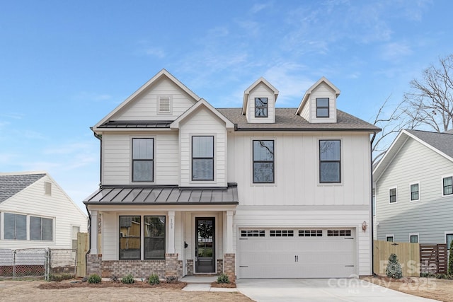 view of front of home featuring metal roof, a standing seam roof, and fence