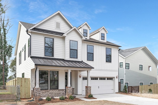 view of front of house featuring driveway, a standing seam roof, fence, metal roof, and a garage