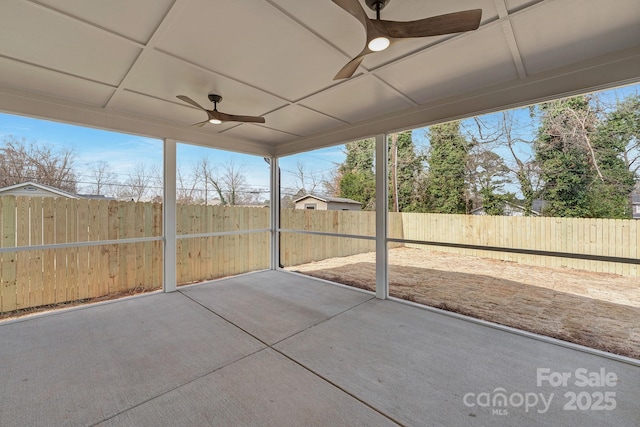 unfurnished sunroom featuring ceiling fan