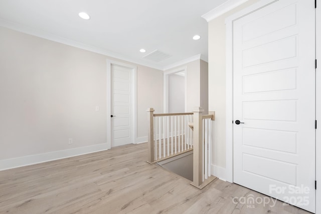 spare room with crown molding, recessed lighting, baseboards, and light wood finished floors