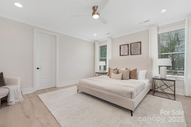 bedroom featuring light wood-type flooring, visible vents, baseboards, and ornamental molding