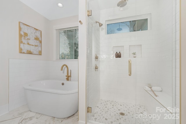 full bath with a shower stall, a freestanding bath, and marble finish floor