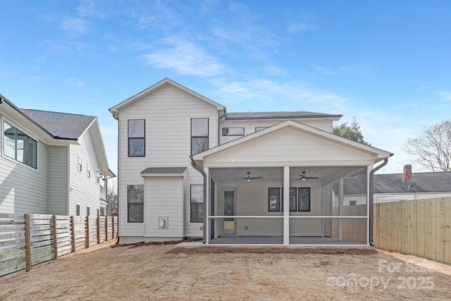 rear view of house with a fenced backyard, a ceiling fan, and a sunroom