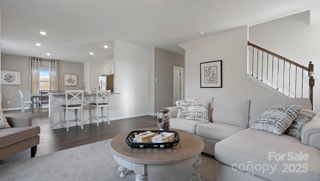 living area featuring recessed lighting, stairs, baseboards, and dark wood-style flooring