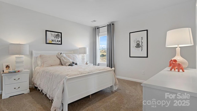 carpeted bedroom with visible vents and baseboards