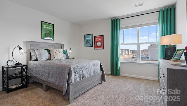 bedroom with baseboards, visible vents, and light carpet