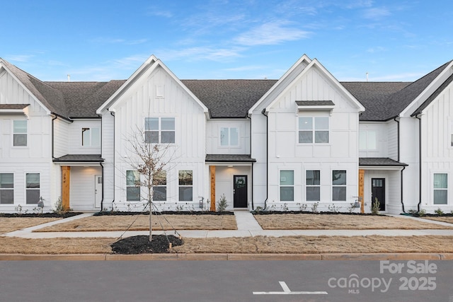 townhome / multi-family property featuring board and batten siding and a shingled roof