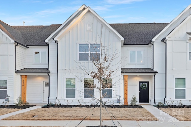 multi unit property with board and batten siding and a shingled roof