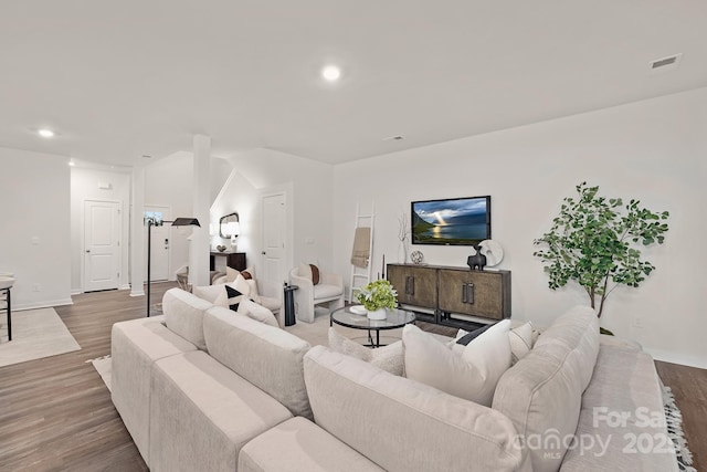 living room with visible vents, recessed lighting, baseboards, and wood finished floors