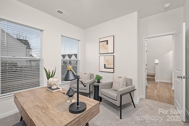 office area with visible vents, baseboards, and carpet