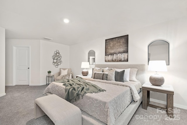 bedroom with arched walkways, carpet, visible vents, and baseboards