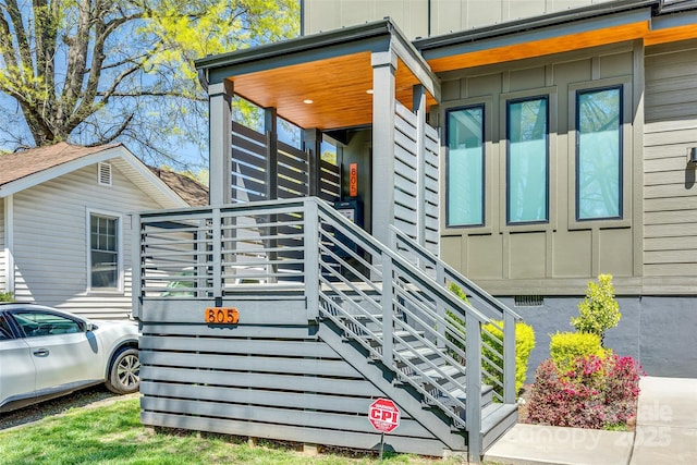 view of side of home featuring stairs and board and batten siding