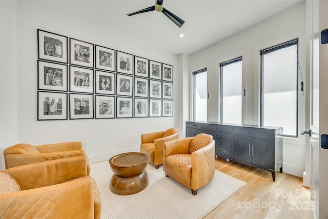 sitting room with light wood-type flooring, baseboards, a ceiling fan, and recessed lighting