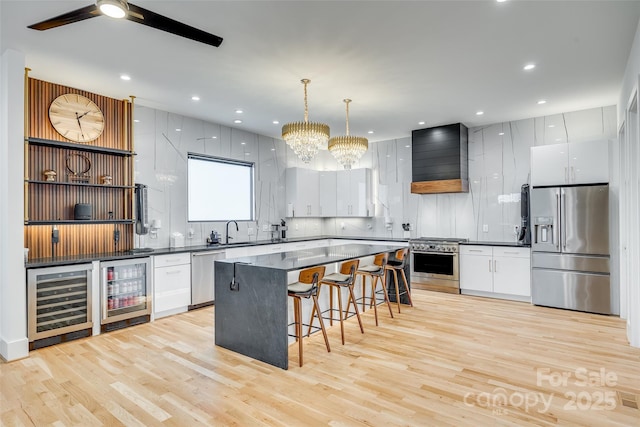 kitchen featuring dark countertops, appliances with stainless steel finishes, and beverage cooler