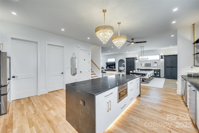 kitchen featuring stainless steel microwave, recessed lighting, and light wood-style floors