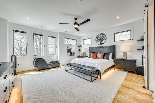 bedroom featuring visible vents, baseboards, light wood-type flooring, a ceiling fan, and recessed lighting