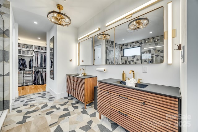 full bath featuring a chandelier, recessed lighting, vanity, and a tile shower