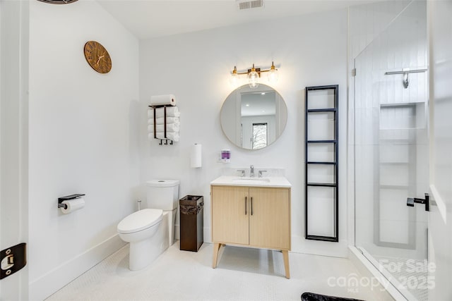 bathroom with a tile shower, vanity, toilet, tile patterned floors, and baseboards