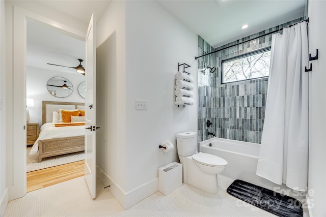 bathroom featuring shower / bath combo, ensuite bathroom, baseboards, toilet, and ceiling fan