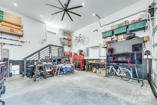garage with ceiling fan and a workshop area