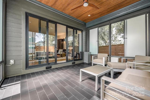 sunroom / solarium with visible vents and ceiling fan