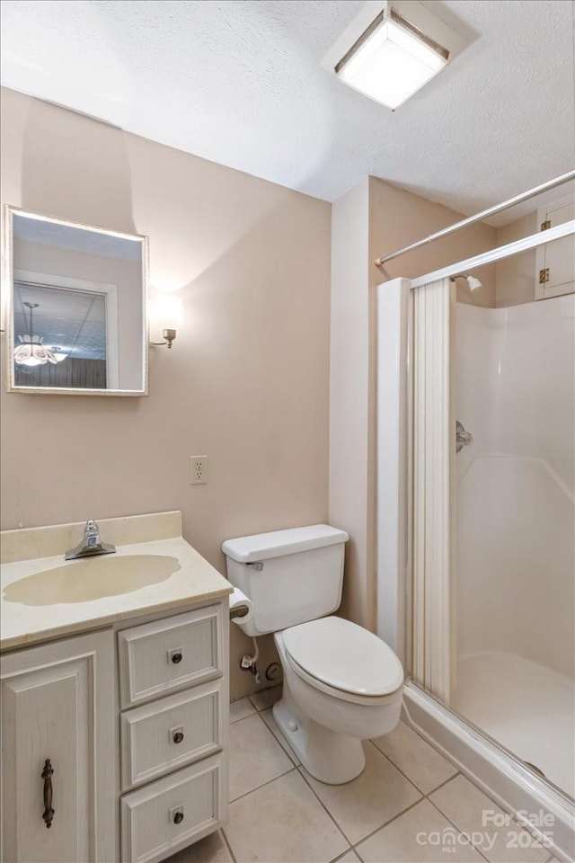 bathroom with tile patterned flooring, toilet, and a stall shower
