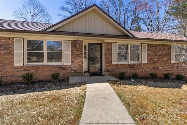 ranch-style house with brick siding and metal roof