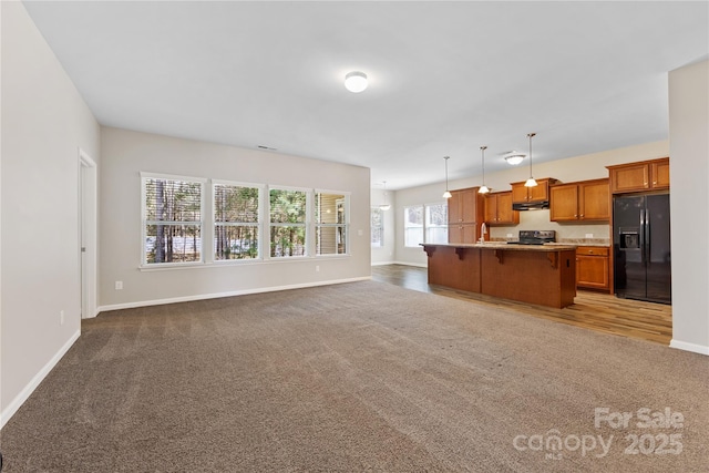 living room featuring baseboards and dark carpet