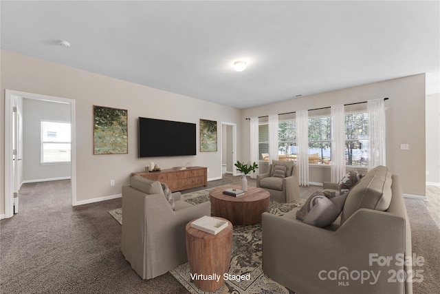 living room with baseboards and carpet