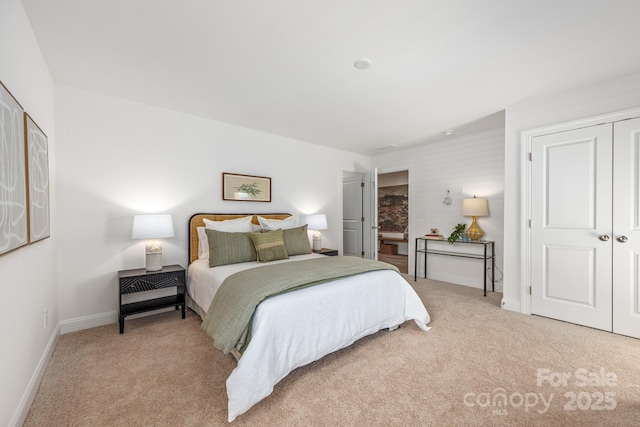 bedroom with a closet, carpet flooring, and baseboards