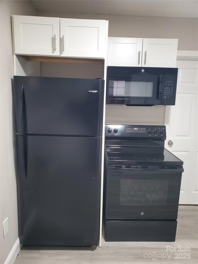 310 Pineview St, Kannapolis, NC 28083 - kitchen featuring black appliances, light wood-style floors, white cabinetry, and baseboards