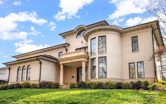 1665 Sterling Rd, Charlotte, NC 28209 - view of front of house with a balcony, brick siding, and a front lawn