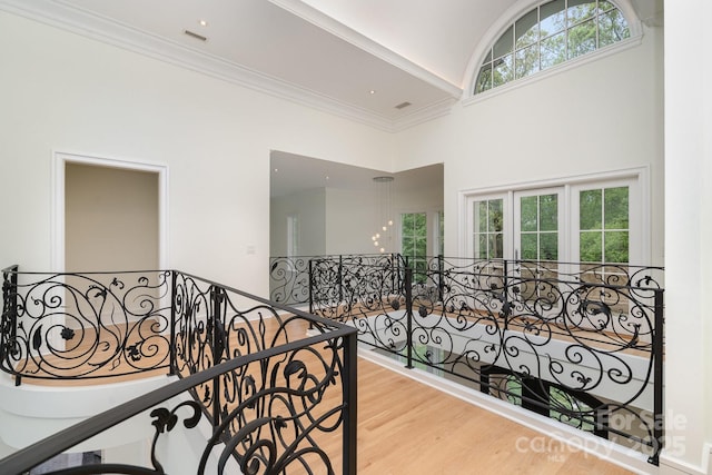 1665 Sterling Rd, Charlotte, NC 28209 - corridor with a high ceiling, an upstairs landing, crown molding, wood finished floors, and a chandelier