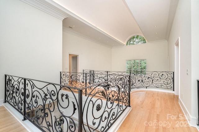 1665 Sterling Rd, Charlotte, NC 28209 - hall with an upstairs landing, vaulted ceiling, wood finished floors, baseboards, and crown molding