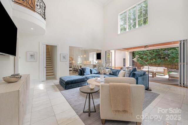 1665 Sterling Rd, Charlotte, NC 28209 - living area featuring a high ceiling, stairs, baseboards, and light tile patterned floors