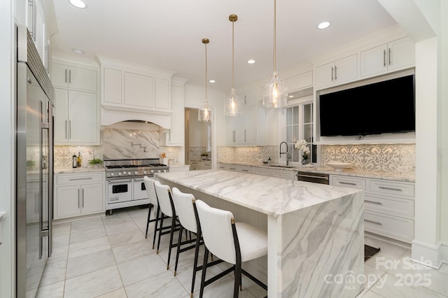 1665 Sterling Rd, Charlotte, NC 28209 - kitchen featuring premium appliances, a sink, decorative backsplash, white cabinets, and a center island