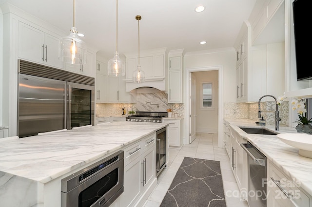 1665 Sterling Rd, Charlotte, NC 28209 - kitchen featuring built in appliances, a sink, recessed lighting, white cabinetry, and decorative backsplash