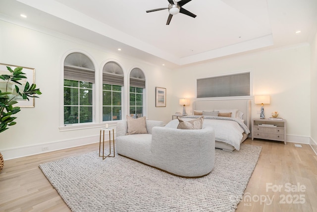 1665 Sterling Rd, Charlotte, NC 28209 - bedroom with light wood-style floors, recessed lighting, baseboards, a tray ceiling, and a ceiling fan