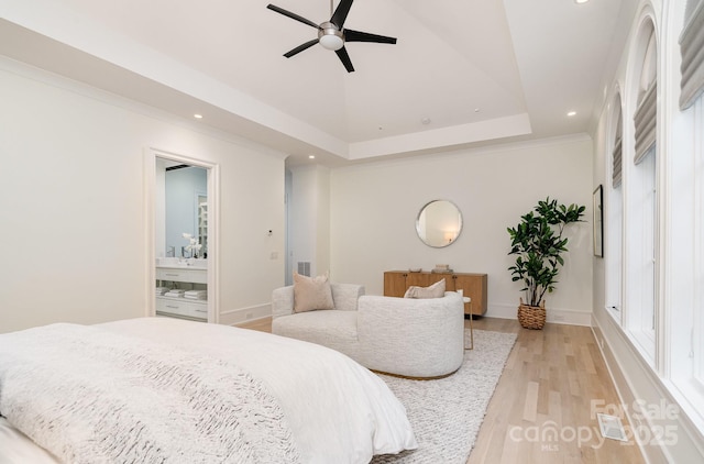 1665 Sterling Rd, Charlotte, NC 28209 - bedroom with recessed lighting, light wood-style floors, baseboards, ensuite bathroom, and a tray ceiling