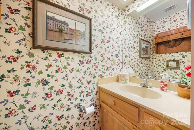 32 Fairway Rdg, Lake Wylie, SC 29710 - bathroom with visible vents, a skylight, vanity, and wallpapered walls