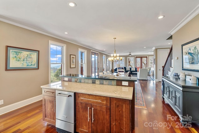 kitchen with a wealth of natural light, open floor plan, and dark wood-style flooring