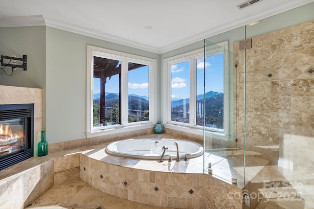 full bathroom featuring a garden tub, plenty of natural light, visible vents, and ornamental molding