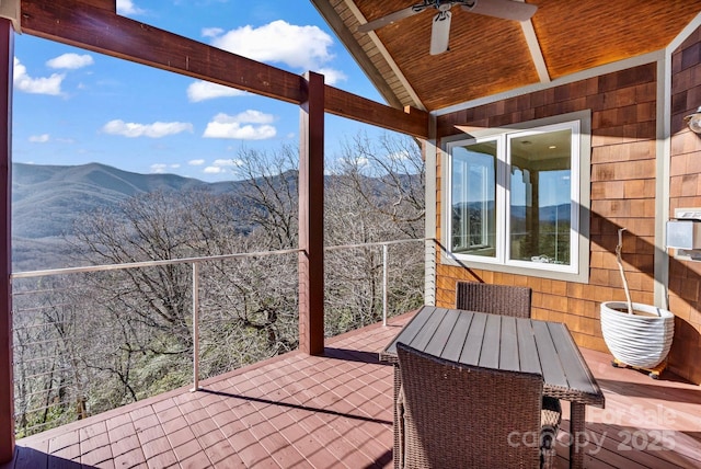 view of patio / terrace with outdoor dining space, a mountain view, and ceiling fan