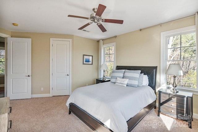 carpeted bedroom featuring visible vents, baseboards, and ceiling fan